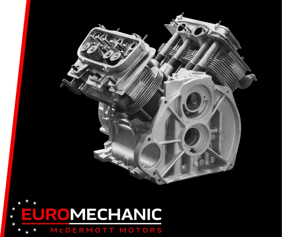 A detailed grayscale image of a mechanical engine component against a black background, symbolizing engine repair expertise in Greater Toronto. The Euro Mechanic and McDermott Motors logo is displayed at the bottom corner in red and white. EuroMechanic | Top Reviewed Auto Repair Shop | Greater Toronto and Guelph | Visit Euromechanic