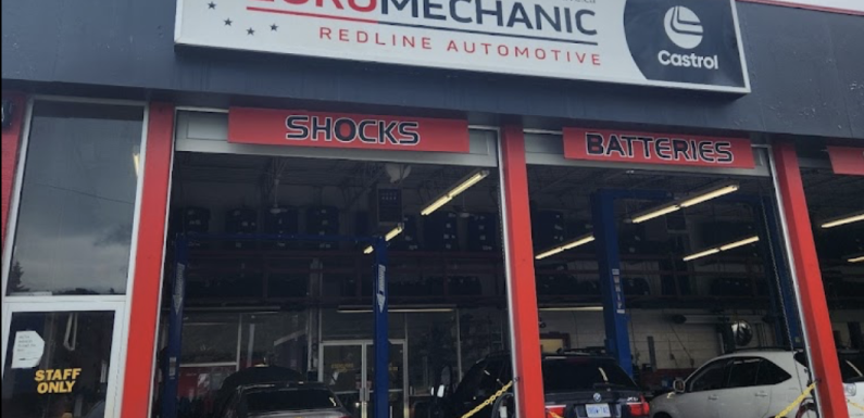 The exterior of Euro Mechanics Redline Automotive features a sign with Castrol branding. The open garage reveals cars inside, ready for service in bays dedicated to shocks and batteries, while a Staff Only door marks the restricted area on the left. EuroMechanic | Top Reviewed Auto Repair Shop | Greater Toronto and Guelph | Visit Euromechanic
