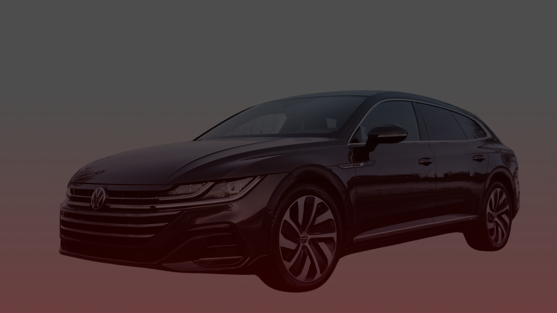 A sleek black Volkswagen Arteon wagon with distinctive alloy wheels is parked against a gradient background transitioning from gray to maroon. Its modern design and aerodynamic features are clearly visible, showcasing the craftsmanship appreciated by Volkswagen mechanics in Greater Toronto and Guelph. EuroMechanic | Top Reviewed Auto Repair Shop | Greater Toronto and Guelph | Visit Euromechanic