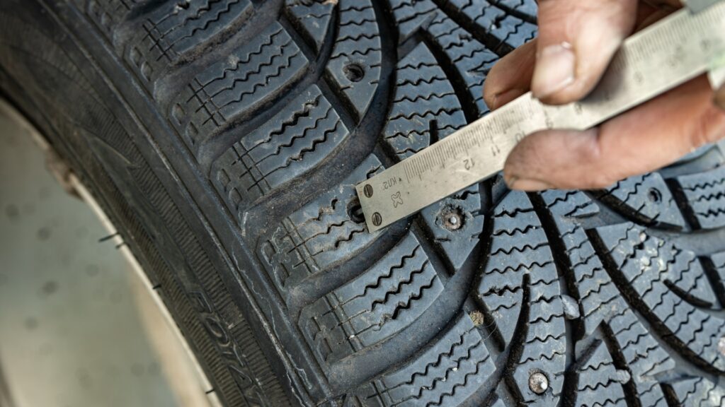 EuroMechanic technician checking winter tire age, tread depth and condition before seasonal installation in Ontario